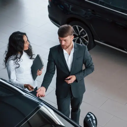 Business executive getting into a corporate taxi in Tirupur